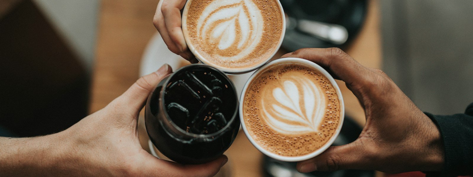 Freshly brewed coffee in a cup with coffee beans