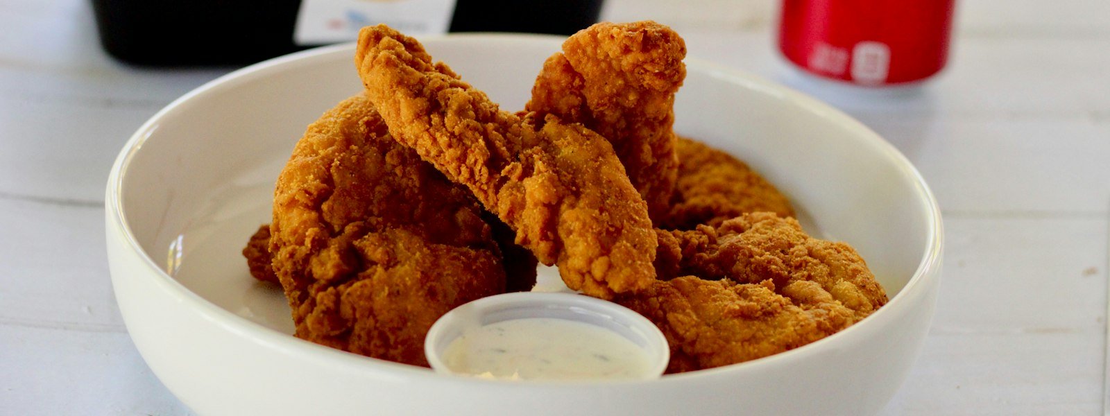 Plate of crispy chicken tenders with ranch dipping sauce