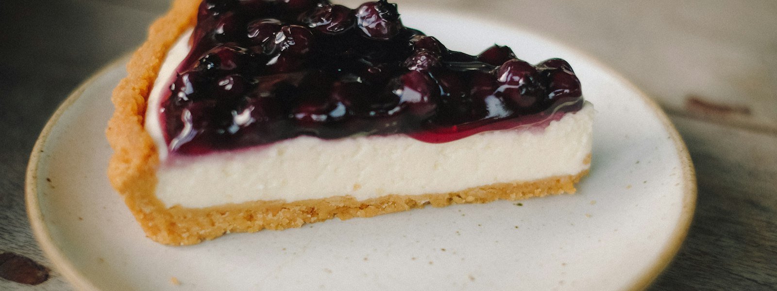 Slice of creamy cheesecake with berry topping
