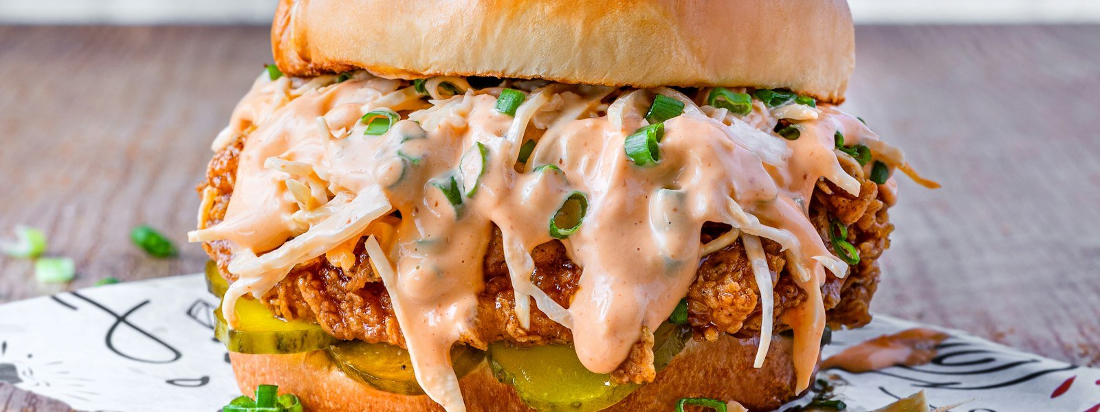 Crispy fried chicken sandwich with pickles on a toasted bun