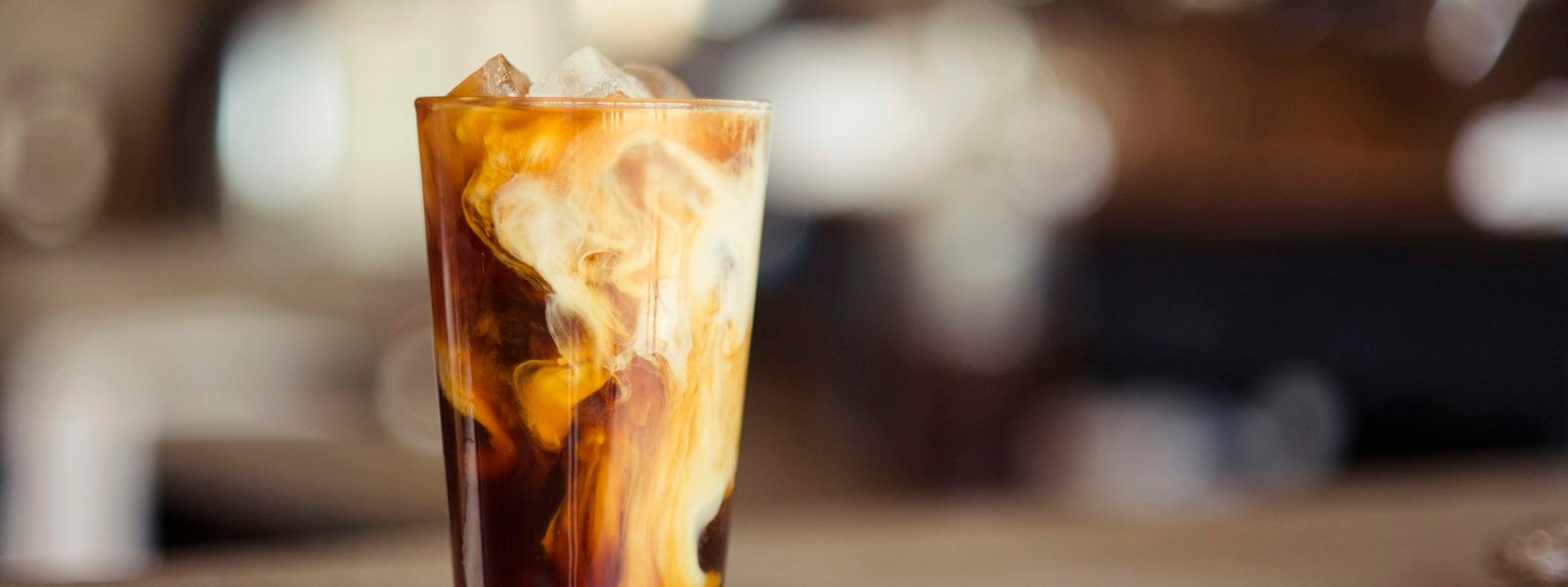 Iced coffee drink with cream in a clear glass