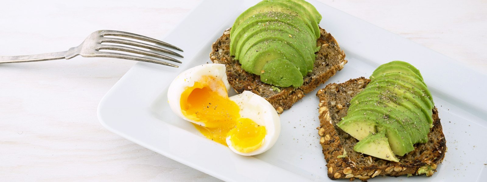 Avocado toast with eggs on a brunch table