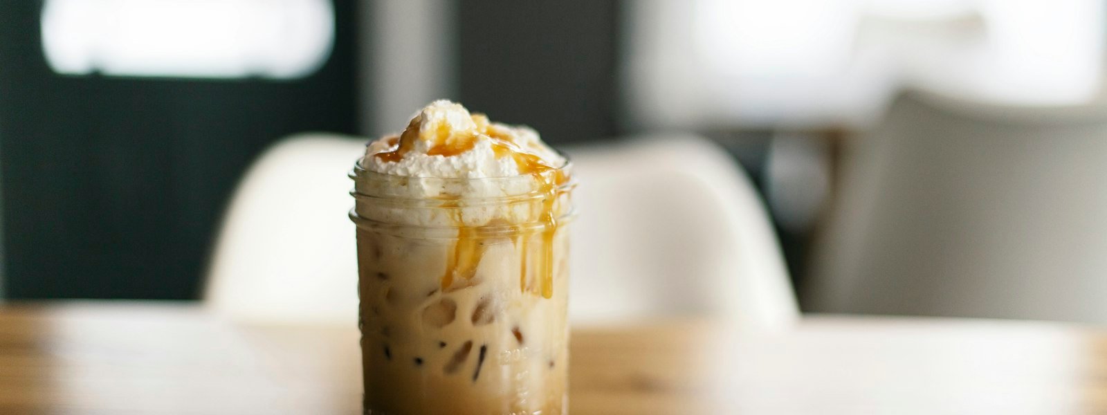 Iced caramel latte topped with whipped cream