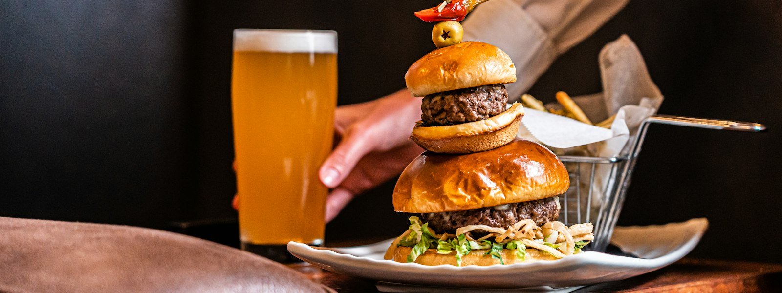 Burgers on a plate with a cold glass of draft beer