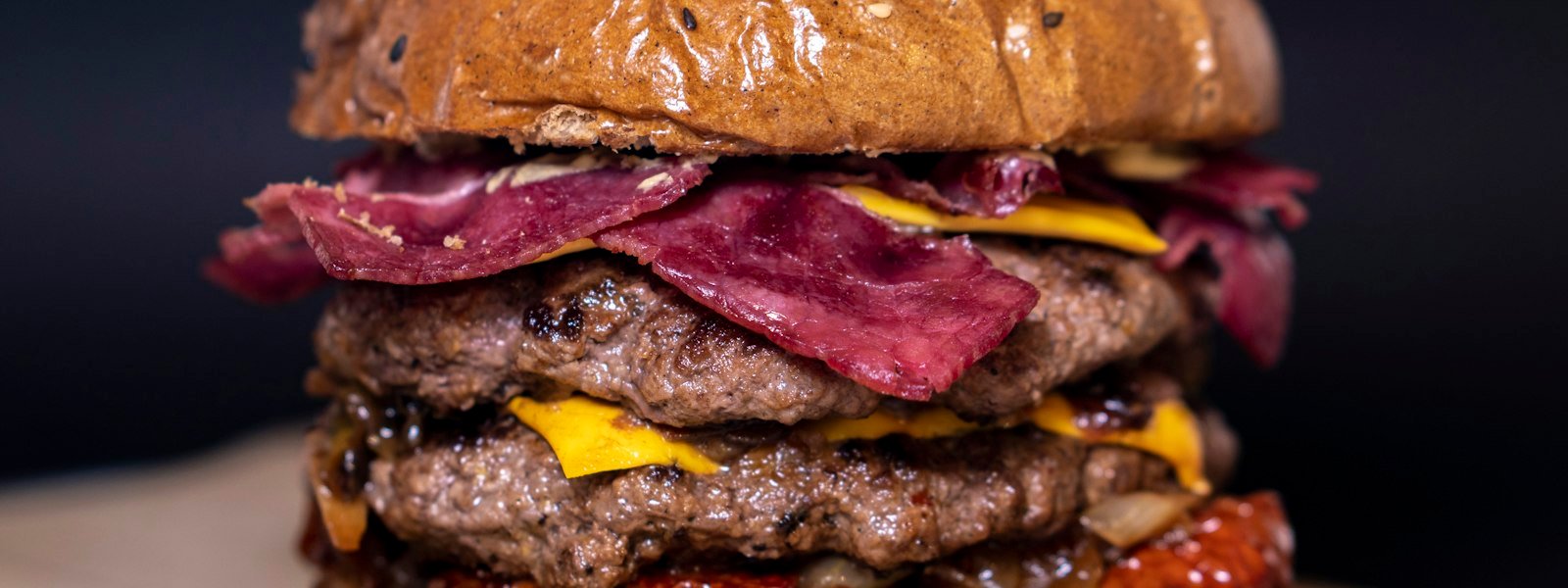 Large burger with melted cheese and onions