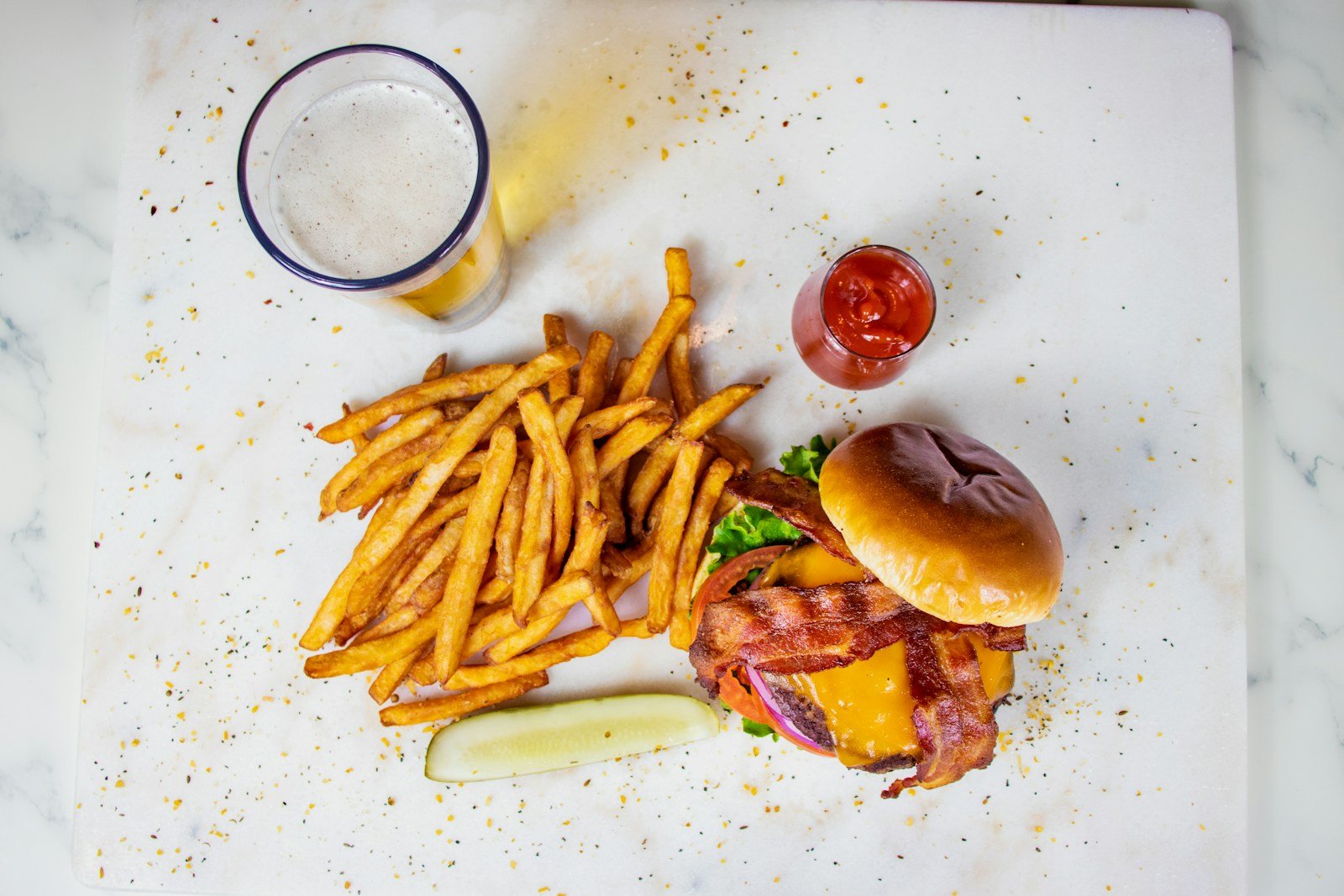Bacon burger with fries and pickles