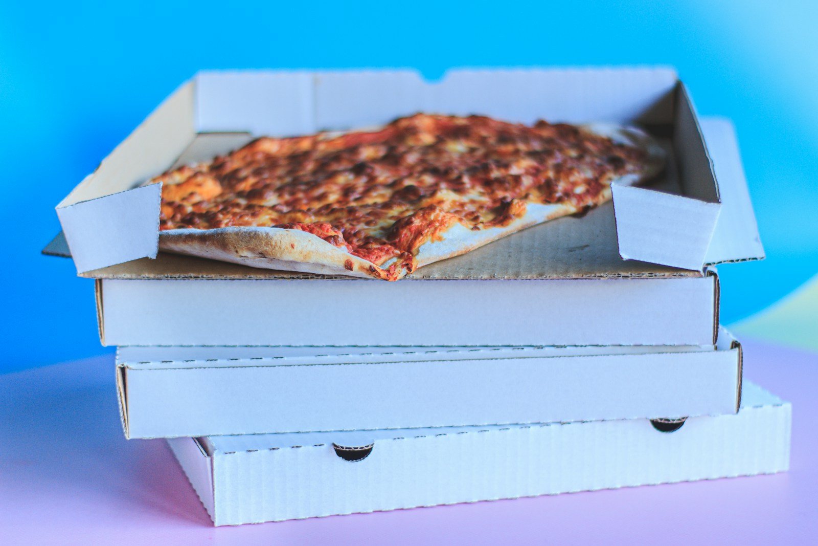 Cheese pizza in an open white pizza box