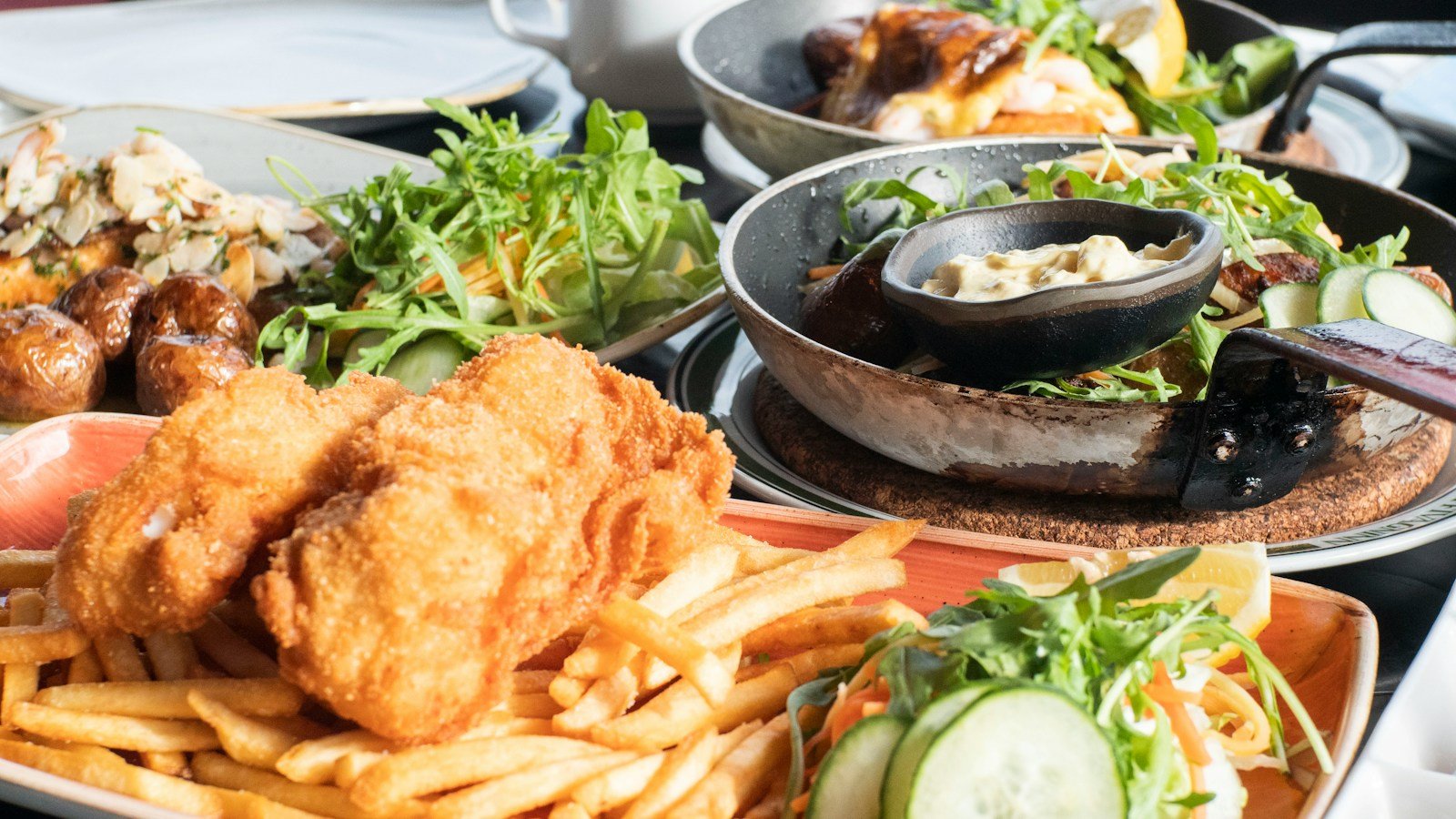 Crispy fried chicken and fries in a black bowl